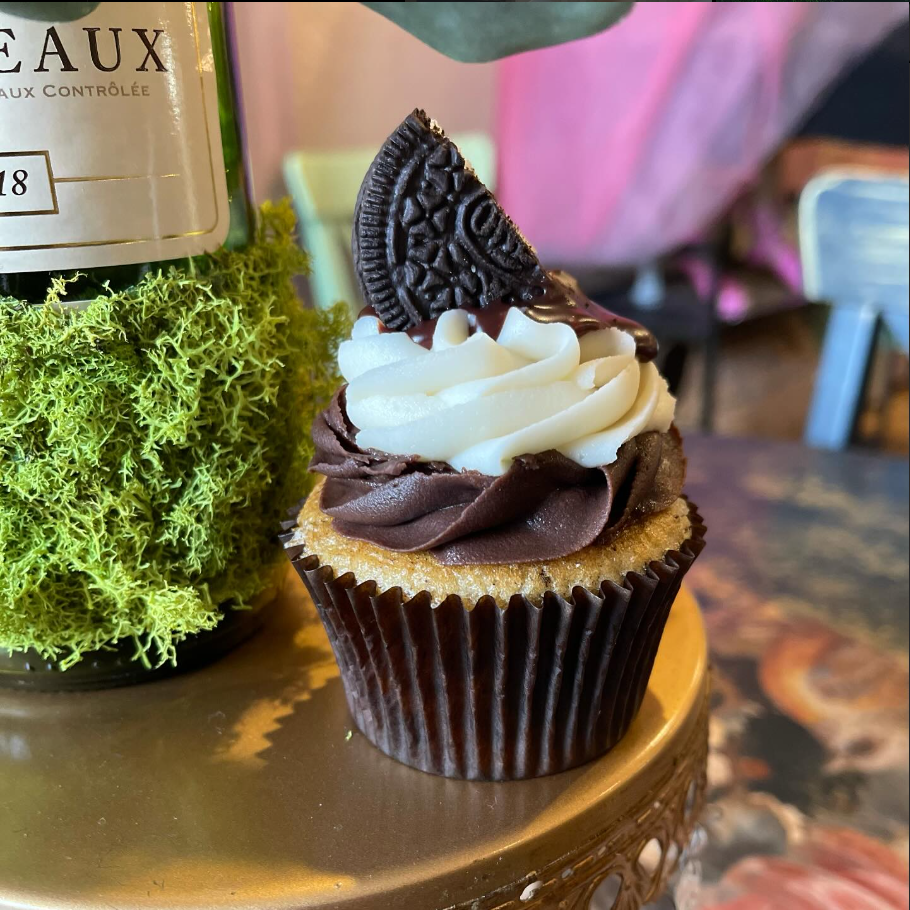 An oreo cupcake next to a decoration on a table