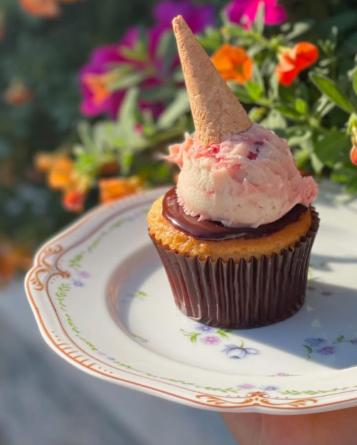 A beautiful cupcake on a delicate china plate